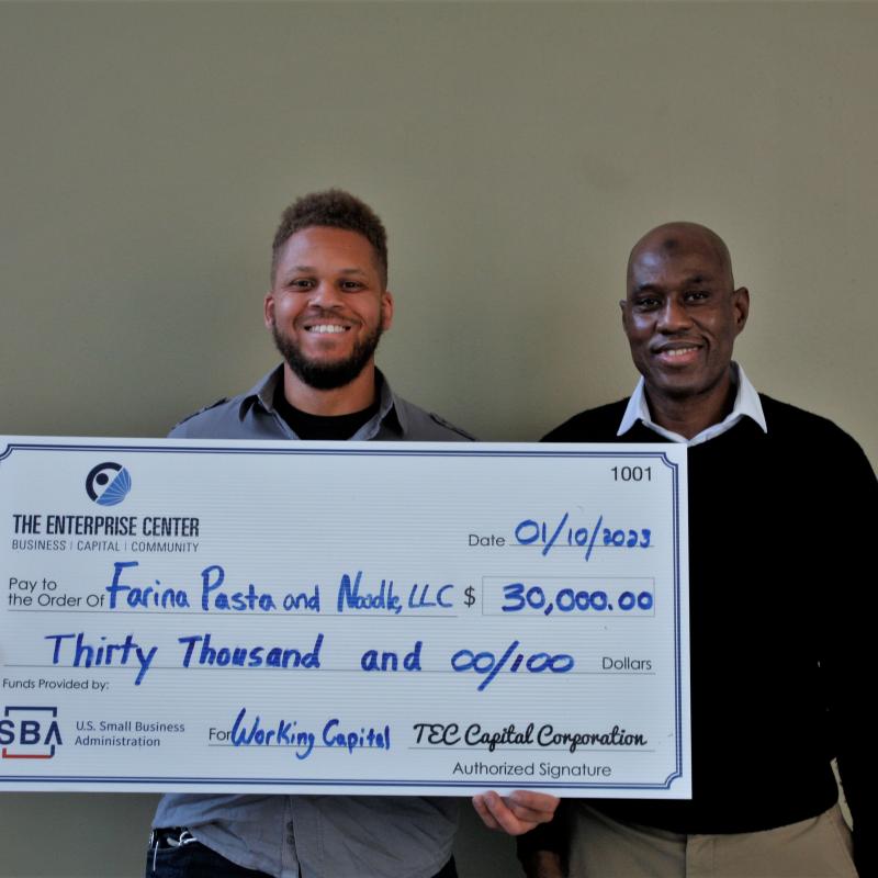 picture of daniel lee and souraghata semega holding a check